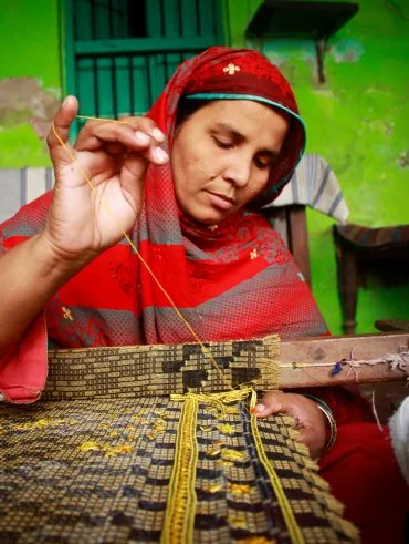 A Bunyad artisan doing hand embroidery