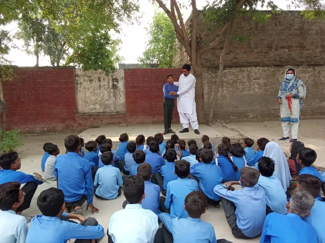 Children at an outdoor awareness session at a Bunyad school